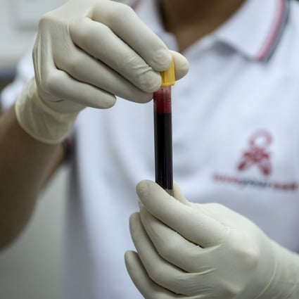 A nurse holds a vial of blood at a testing centre in Manila. Photo: AFP