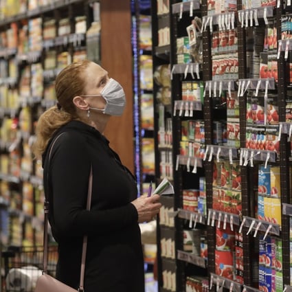Shopper Erin Call wears a mask as she shops for groceries at Harmons grocery store Friday, April 3, 2020, in Salt Lake City. Photo: AP