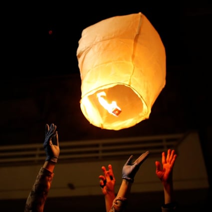 People in the small southern Italian town of San Giorgio Ionico light a paper lantern in memory of those who have died in the coronavirus pandemic. Photo: Reuters