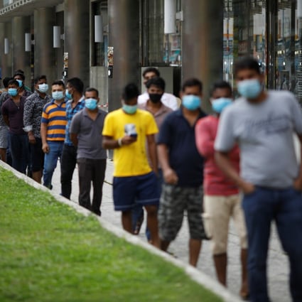 Migrant workers wait for meals in Little India district in Singapore. The outbreak of Covid-19 in foreign worker dormitories was predicted and is a mistake Singapore must learn from. Photo: Reuters