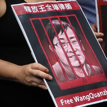 A picture of Chinese human rights lawyer Wang Quanzhang is held up during a silent protest outside the Hong Kong Court of Final Appeal, on July 9, 2018, the third anniversary of China’s “709” crackdown on human rights lawyers. Photo: K.Y. Cheng