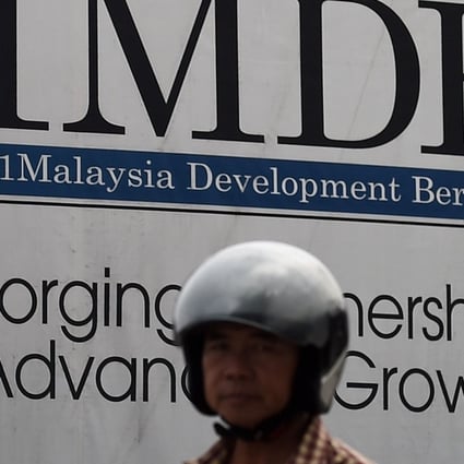 A motorist rides past a hoarding at a construction site funded by 1MDB in Kuala Lumpur in this 2015 file photo. Photo: AFP
