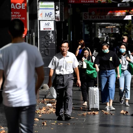People walk in the streets of Sydney's central business district in Australia on April 11. 2020. Social distancing and other restrictions imposed by authorities are expected to lead to soaring unemployment. Photo: Agence France-Presse