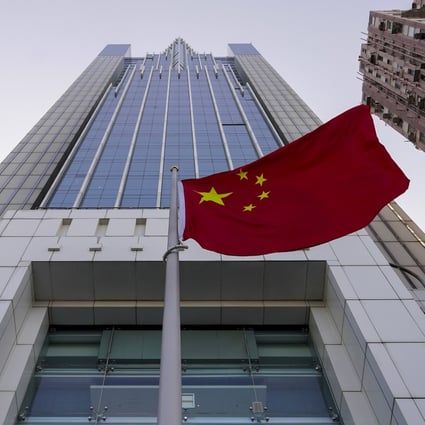 The national flag flutters in the breeze outside China’s liaison office building in Hong Kong. Photo: AP