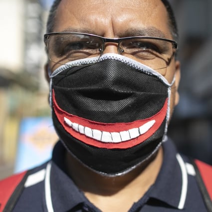 A man wears a face mask in Caracas, Venezuela. People with glasses know that masks cause the lenses to fog up with every breath. Photo: AP