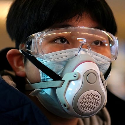 A passenger wearing a protective mask arrives at a railway station in Wuhan on the first day inbound train services resumed following the coronavirus outbreak. Photo: Reuters