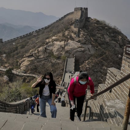 Women wearing protective face masks to prevent the spread of the new coronavirus walk on a stretch of the Badaling Great Wall of China in Beijing, Tuesday, April 14, 2020. Photo: AP