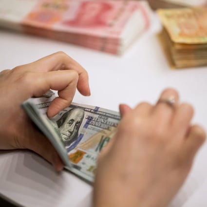 An employee counts US$100 banknotes at the Hang Seng Bank headquarters in Hong Kong on Tuesday, April 16, 2019. Photo: Bloomberg