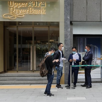 A few potential buyers queue up for Longfor Group and KWG Group’s Upper Riverbank residential project coming up in Kai Tak, on Friday. Photo: Edmond So