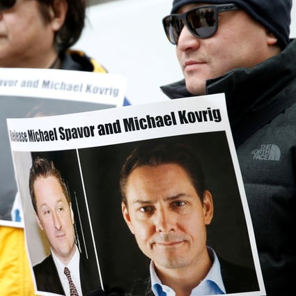 People hold signs calling for China to release Canadian detainees Michael Spavor and Michael Kovrig during an extradition hearing for Huawei executive Meng Wanzhou at the British Columbia Supreme Court in Vancouver in March. Photo: Reuters