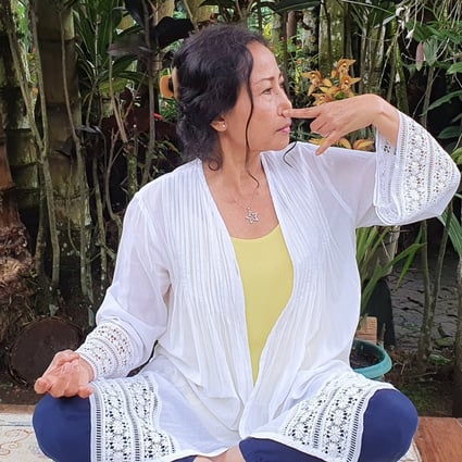 Sutha Atiin practising a meditative breathing technique. She, like many others during the coronavirus pandemic, is turning to meditation to stay calm and focused. Photo: Angela Jelita