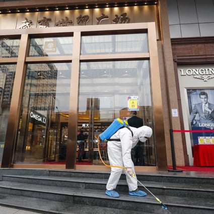 The entrance of a shopping centre in Wuhan is disinfected. Fashion designers in China who have physical stores are facing a dilemma: to move sales online, or hope for a pickup in physical sales. Photo: Xinhua