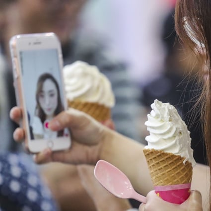 People take selfies with their food on the second day of the HKTDC Food Expo, International Tea Fair, Home Delights Expo and Beauty and Wellness Expo, at the Hong Kong Convention and Exhibition Centre in Wan Chai. File photo: SCMP / K. Y. Cheng