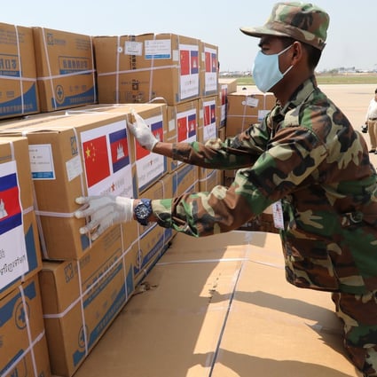 A Cambodian soldier unloads medical supplies donated by China on Saturday at Phnom Penh International Airport. Photo: EPA-EFE