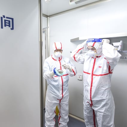 Researchers put on protective suits at the Wuhan Institute of Virology. Photo: Xinhua