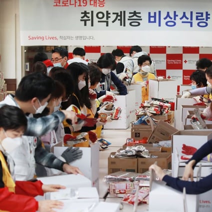 Red Cross officials prepare emergency food packages for the needy in Seoul on April 28, 2020. Photo: EPA-EFE/YONHAP SOUTH KOREA OUT