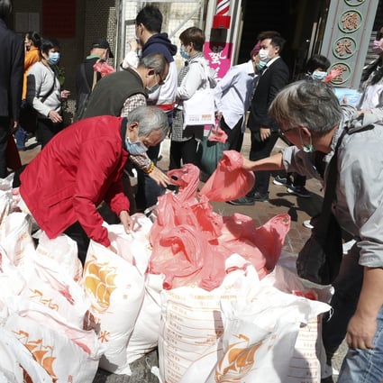 People queuing up for rice distributed by a shop in Sham Shui Po in February. Photo: Nora Tam