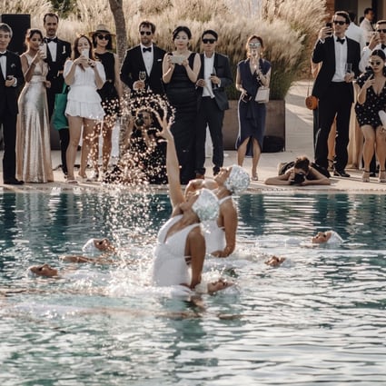 A couple who met in the lift of the Mandarin Oriental Hong Kong hotel married in a lavish wedding in Ibiza, Spain – complete with synchronised swimmers, celebrity DJs and waiters who broke out into song.