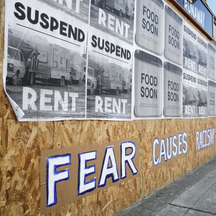 A sign that reads “Fear causes racism” is seen on a boarded-up shopfront in Seattle, Washington, in March. Photo: Reuters
