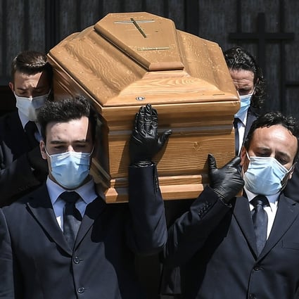Pallbearers carry the coffin of a coronavirus victim out of a church in Brescia, Italy on Monday. Photo: dpa