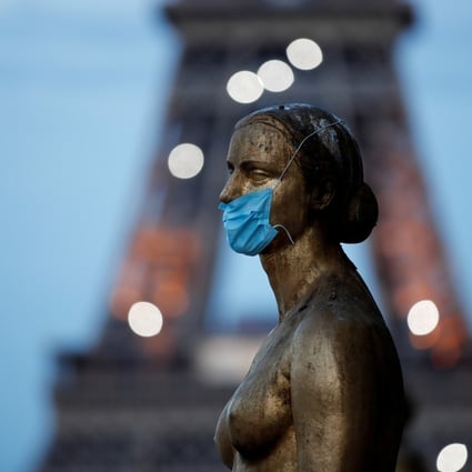 Paris’ Golden Statue, near the Eiffel Tower, is adorned with a surgical mask, in acknowledgement of an outbreak that may have reached France in December. Photo: Reuters
