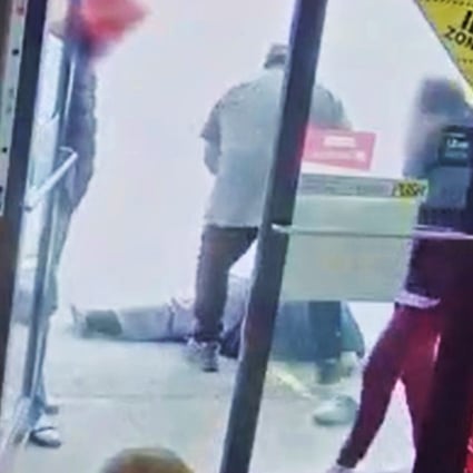 The suspect in a racist attack on an elderly Asian man stands over his victim outside a Vancouver convenience store on March 13, in a video released by Vancouver police. Photo: Vancouver Police Department