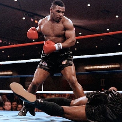 Mike Tyson became the youngest heavyweight champion at 20 years old when he knocked out Trevor Berbick in 1986. Photo: AFP/Getty Images