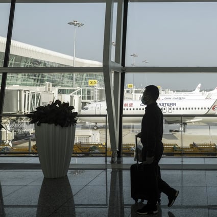 A passenger wearing a protective mask walks past China Eastern Airlines Corp. aircraft standing on the tarmac at the Wuhan Tianhe International Airport in Wuhan, China, on May 2. Photo: Bloomberg