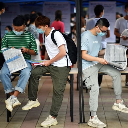 Jobseekers read the ads at an employment fair in Haikou, Hainan Island. China’s “100-day” campaign highlights the urgency for young people to find work. Photo: Xinhua