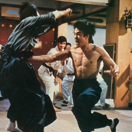 Bruce Lee in a still from Enter the Dragon, his most famous film that also featured Jackie Chan as a stuntman and extra.