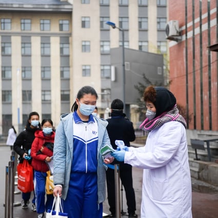 Students wait in line to get their body temperature checked at the No 87 Middle School in Changchun, northeast China's Jilin province, on April 20, 2020. Photo: Xinhua