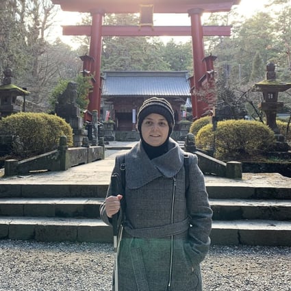 Mona Minkara stands in front of a tall red gate at the Fujiyoshida Sengen Shrine in Japan. The bioengineering professor films her travels on YouTube to show how the visually impaired can journey on their own using public transport. Photo: courtesy of Mona Minkara