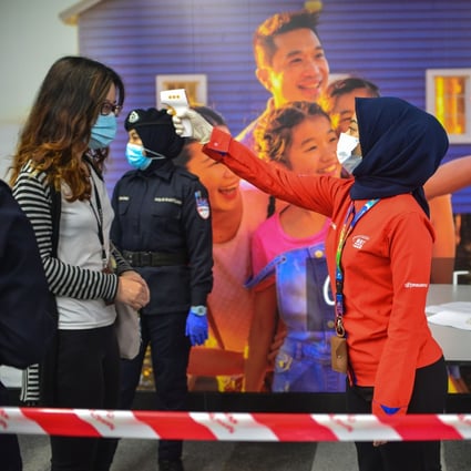 Staff on Kuala Lumpur’s light rail conduct temperature tests on passengers. Malaysia has been impacted by partial lockdown measures to curb the spread of coronavirus since March 18. Photo: Xinhua