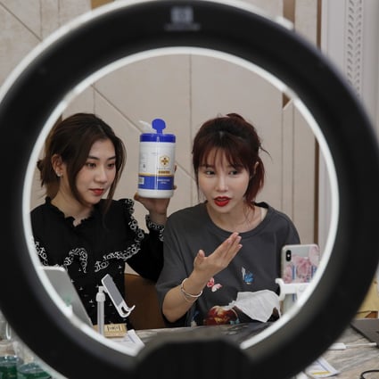 Chinese online celebrity Zhang Mofan (right) introduces disinfectant wipes to her online clients and fans via a live-streaming session from her flat in Beijing on May 5. Photo: AP