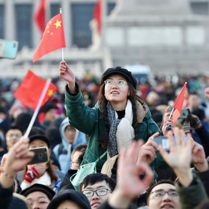 People wave Chinese flags as they gather for a flag-raising ceremony to mark the New Year in Tiananmen Square in Beijing. Photo: Reuters