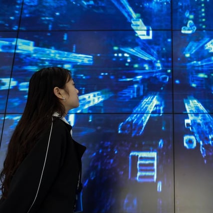 A staff member passes a display at China’s Telecom’s cloud computing facility in Guian New Area, in the southwestern province of Guizhou – the country’s designated big data hub. Photo: Xinhua