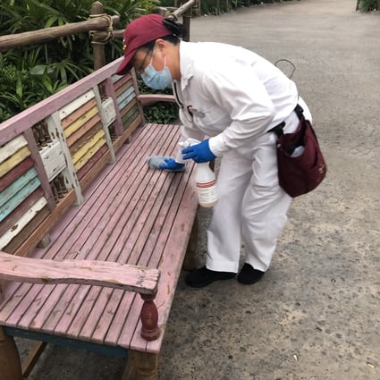 A worker sterilises a bench at Shanghai Disneyland on Monday. Photo: Daniel Ren