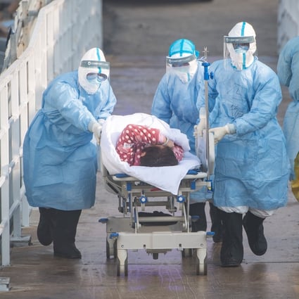 Medical workers take a coronavirus patient to hospital in Wuhan, the outbreak’s initial epicentre. Photo: Xinhua