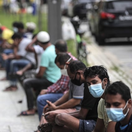 Migrant workers in Singapore queue at a meal distribution point in the Little India district. Photo: EPA