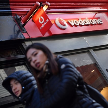 The logo of British mobile phone giant Vodafone is seen on a retail shop in central London. Photo: AFP