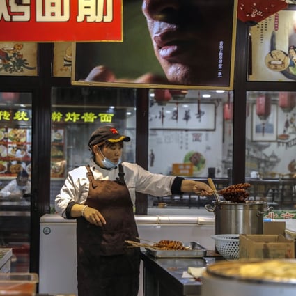 A cook works in a restaurant in Beijing. The coronavirus will transform food and beverage businesses, as economies become more digital and automated. Photo: EPA-EFE