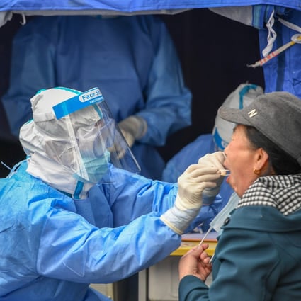A medical worker takes a swab in Shulan, Jilin province. The city has been locked down to contain a cluster outbreak. Photo: Xinhua