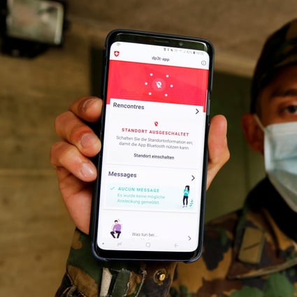 A Swiss soldier shows a contact tracking app created by the Swiss Federal Institute of Technology Lausanne, using Bluetooth and a design called Decentralised Privacy-Preserving Proximity Tracing (DP-3T). Photo: Reuters