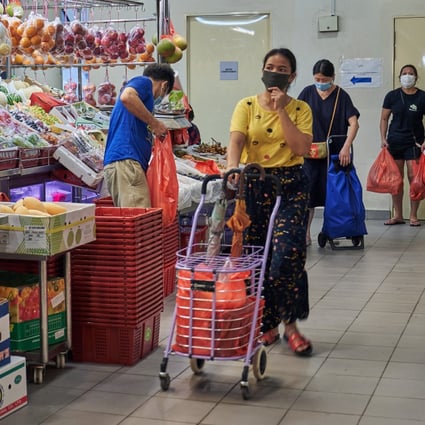Customers shop at a market in Singapore on May 20, 2020. Photo: Bloomberg