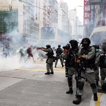 Riot police fire tear gas at the junction of Hennessy Road and Percival Street. Photo: Sam Tsang