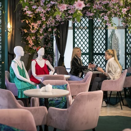 Two friends dine next to mannequins dressed in creations by local designers placed to provide social distancing at a restaurant in Vilnius, Lithuania. Photo: AP