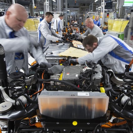 Volkswagen workers are shown at an assembly line for the company’s ID.3 electric vehicle at the German carmaker’s plant in the town of Zwickau on February 25. The ID.3 is one of 70 new electric models that Volkswagen plans to bring to market in the coming years. Photo: AP