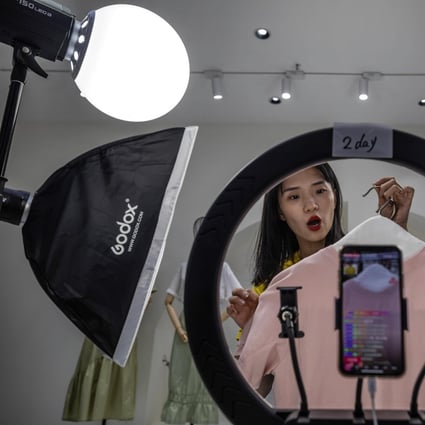 A host presents goods for sale online in the Gonoy Clothing Company studio in Guangzhou, China, May 20, 2020. Tapping into live streaming has become a hot trend in China this year. Photo: EPA-EFE