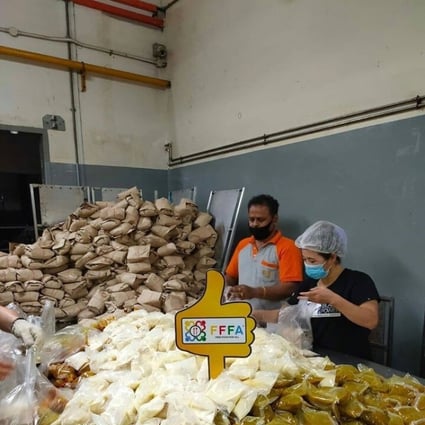 Volunteers at Free Food For All in Singapore prepare meals for low-income households. Photo: Facebook / Free Food For All