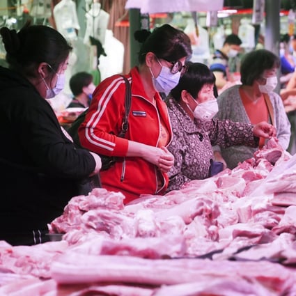 Consumers are seen buying pork at a market in Beijing on May 5. Prices have eased since the Lunar New Year amid rising supply from local and import sources. Photo: Kyodo